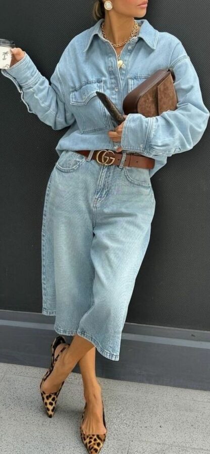 Woman wearing a light denim button-up shirt and wide baggy culotte jeans with leopard heels