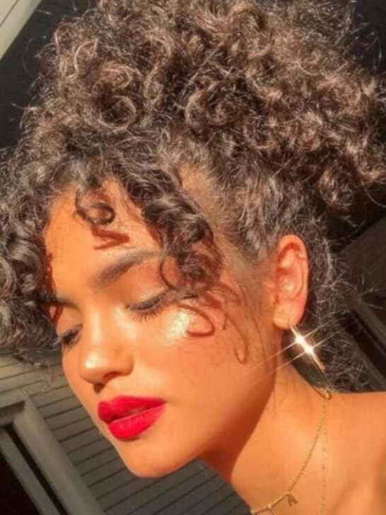 High ponytail featuring lush, voluminous curls.