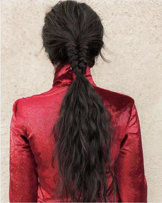 Low ponytail with a fishtail braid at the base for a unique twist.