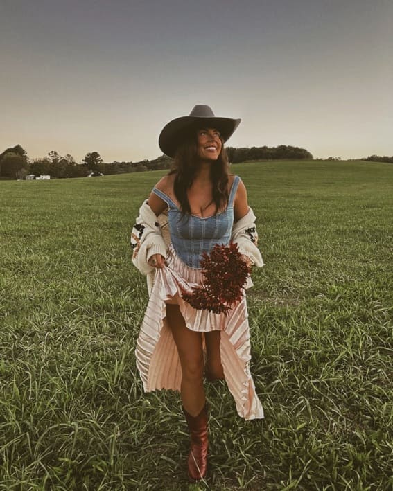 A fun Western outfit includes a striped skirt, cardigan, and cowboy boots. 