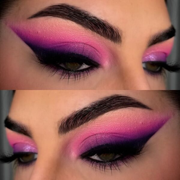 Close-up of vibrant pink and purple smokey eye makeup with a sharp winged liner.