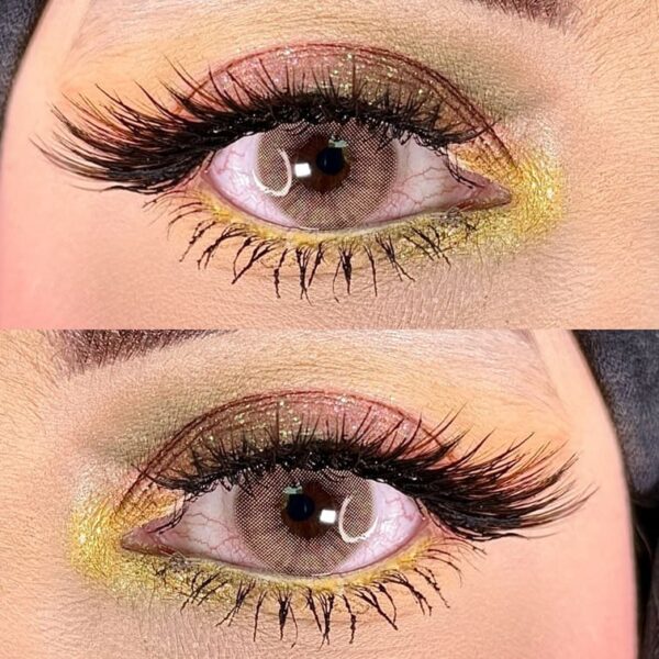 Close-up of a golden and yellow eye makeup look with long lashes.