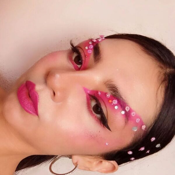 Side profile of pink eyeliner with rhinestone accents along the brow line.