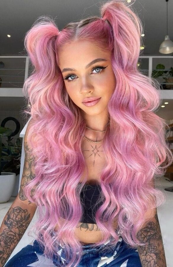 Girl with long wavy pastel pink hair styled in high pigtails