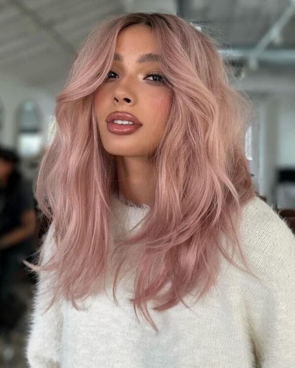 Front view of a dusty rose with soft layers of hair framing the face.