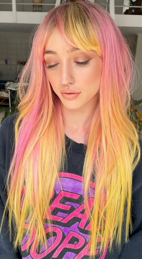 Long straight hair with pink and yellow gradient and curtain bangs