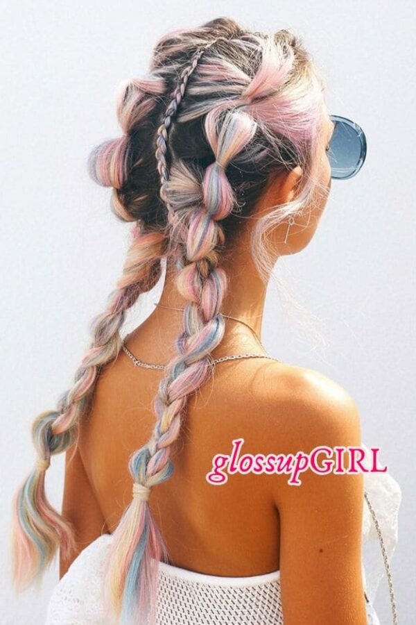 Pastel Festival Braids with Bubble Detail Pastel pink, blue, and blonde festival braids styled into a playful updo with one bubble braid and one loose braid. This hairstyle is so pretty and dreamy. The soft pastel colors make it feel fun and a little whimsical, and the mix of braids and twisted pieces gives it that cool festival look that feels styled without trying too hard. Twist and pin sections of your hair up, then create one chunky bubble braid and one loose braid for that mixed look. Add pastel pink and blue extensions through the hair to get that soft cotton candy color effect.