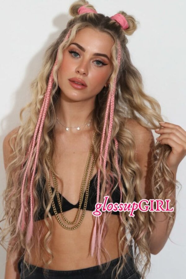 Long blonde wavy hair with two space buns, pink braided face-framing pieces, and soft pink peekaboo streaks.