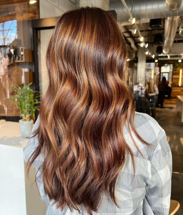 Long wavy hair with chocolate and copper balayage.