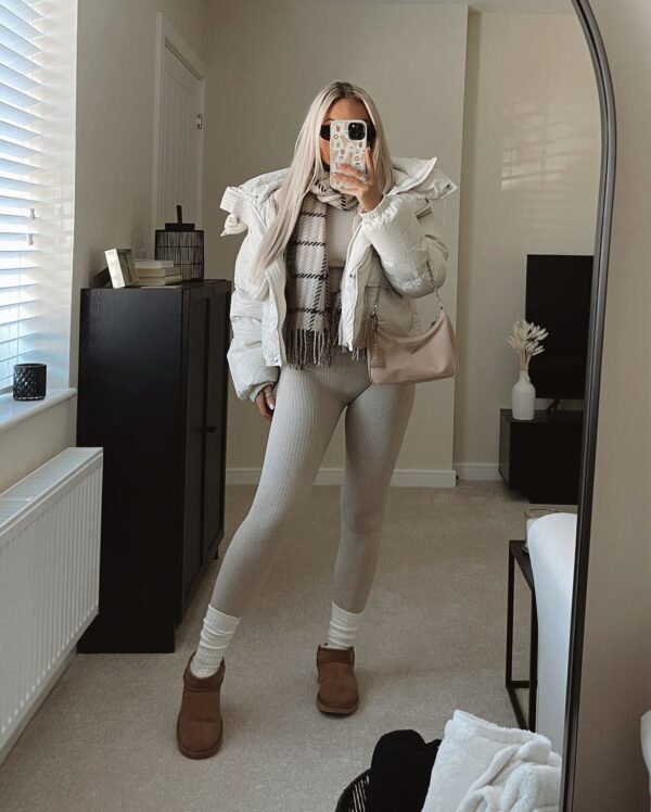 Cozy athleisure outfit featuring a white puffer jacket, ribbed leggings, and UGG Tasman slippers.