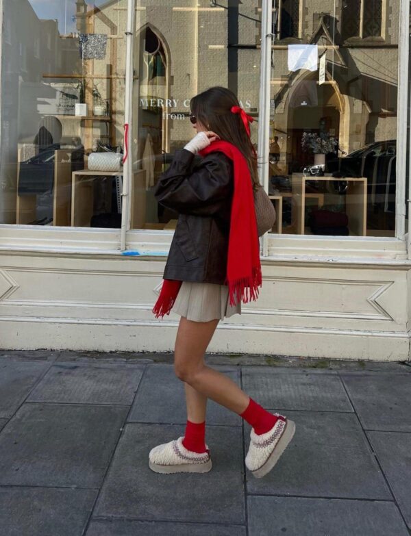 Casual winter outfit with red accents and UGG Tasman slippers.