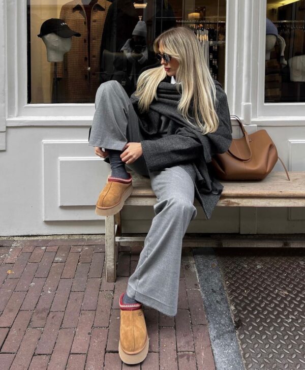 Sophisticated ensemble with wide-leg trousers, an oversized wrap, and UGG Tasman slippers.