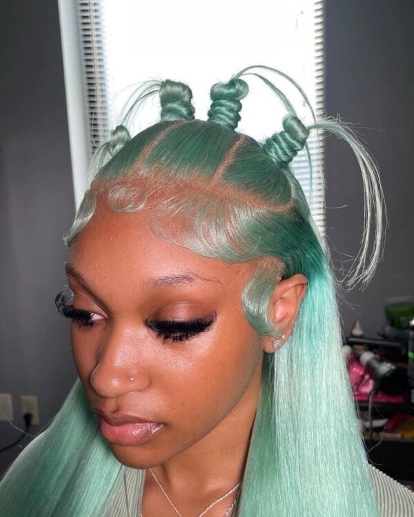 Front view of a mint green wig styled in mini knots with slicked baby hairs.