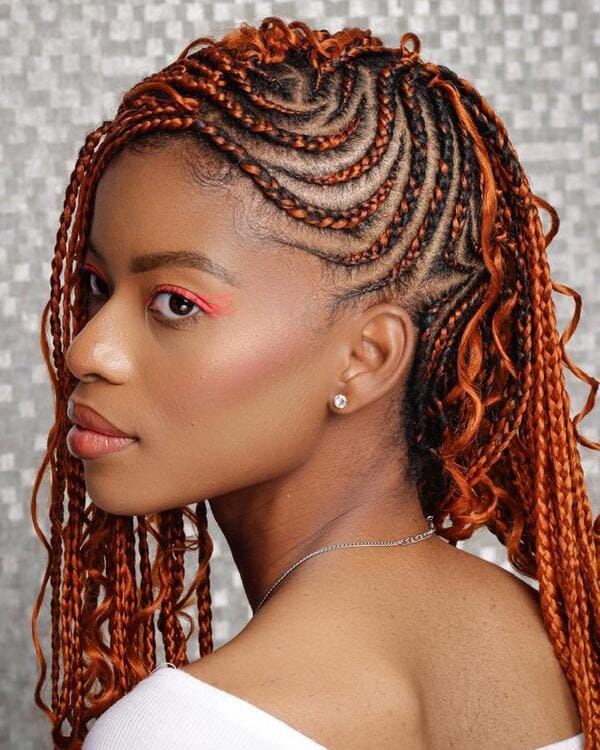 Bold orange Goddess Braids that have loose ends