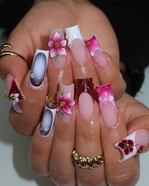 Pink, burgundy, and white 3D sculpted nail art featuring flowers, bubbles, and intricate raised designs.