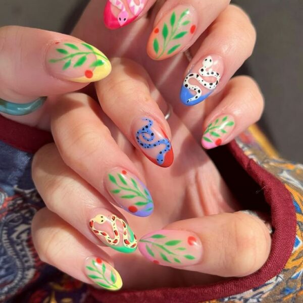 Colorful almond-shaped nails with painted snakes, leafy branches, and bright accent tips.
