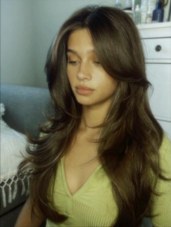 Long wavy hair with curtain bangs and soft layers