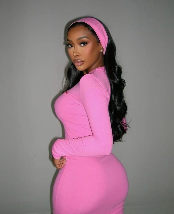 Long black wavy hair styled with a pink headband and matching dress
