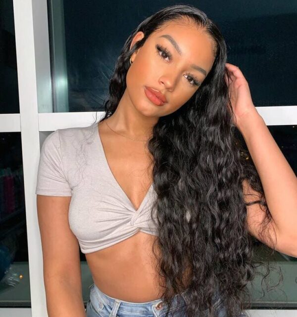 Long black wavy hair styled with a wet-look finish and deep side part
